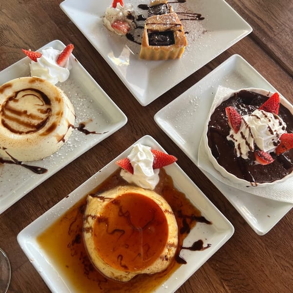 Four Italian desserts on white plates, including flan, chocolate lava cake, and a pastry tart.