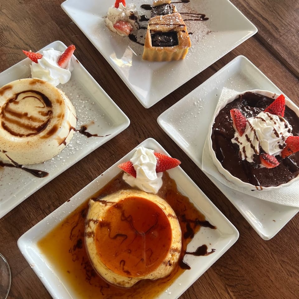 Four Italian desserts on white plates, including flan, chocolate lava cake, and a pastry tart.